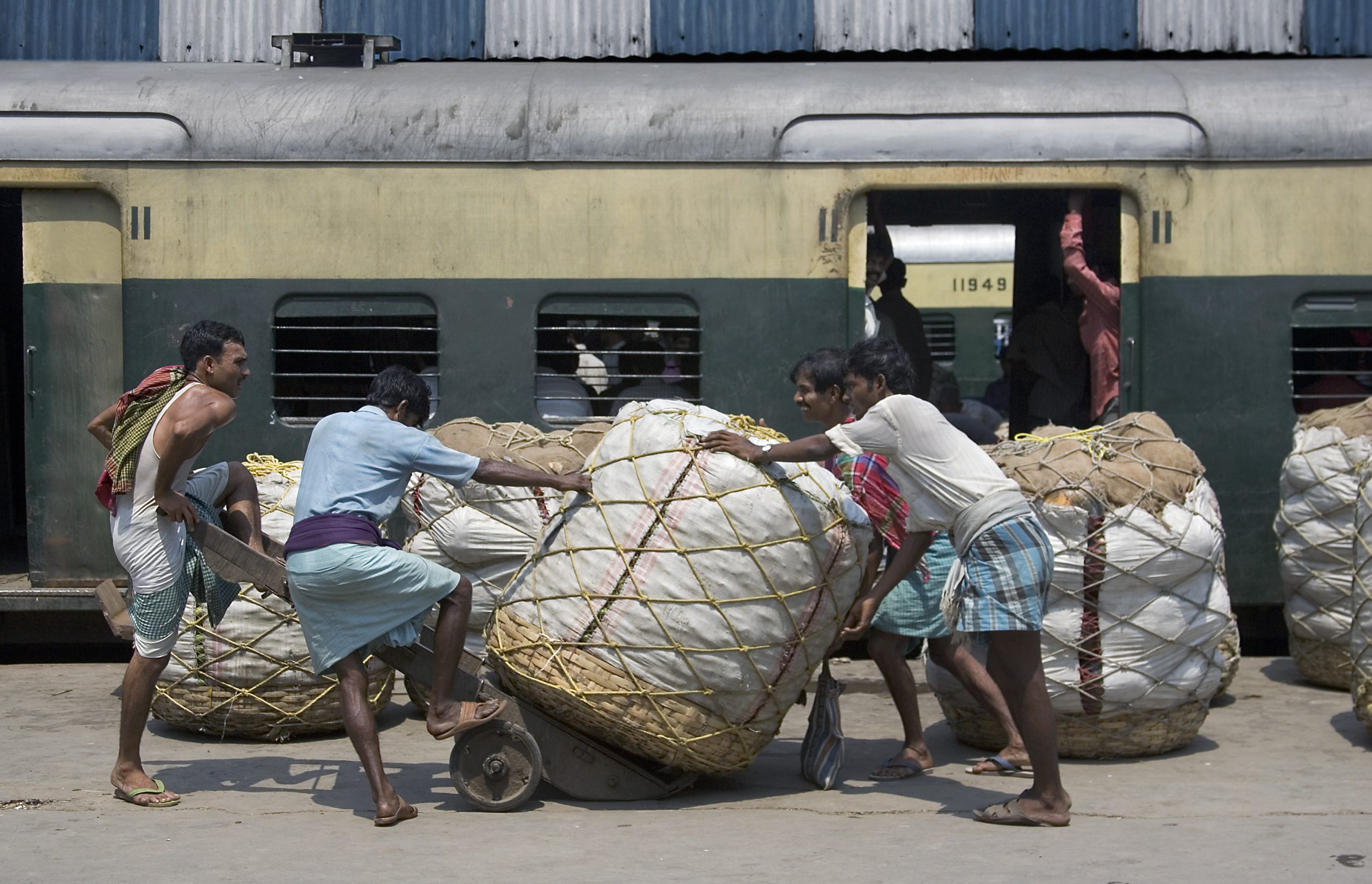 Pushing cotton bales in a railway station, Calcutta Kolkata Indi